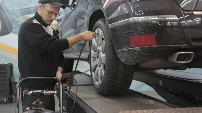 mechanic checking tire air pressure